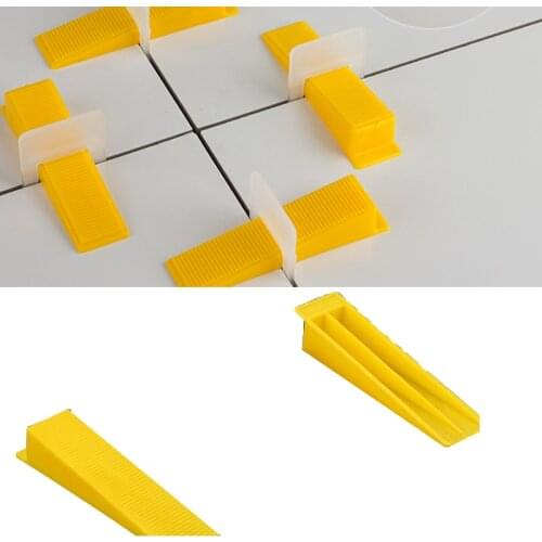 Yellow wedges for tile spacer for wall and floor tool