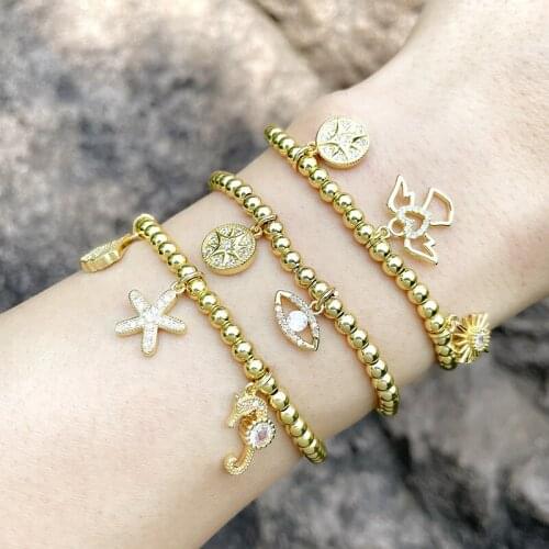 EYIKA Exquisite Elastic Gold Beaded Chain Shell Starfish Sun Star Eye Angel Penadant Bracelet for Woman Zircon Statement Jewelry