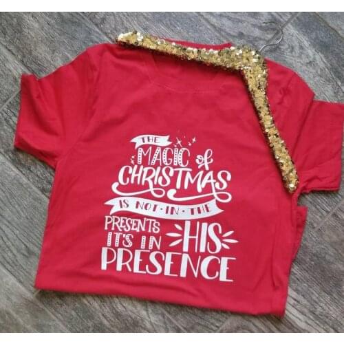 The Magic of Christmas is not in the Presents its in His Presence Unisex slogan Holiday Shirt Graphic Tee Religious T-Shirt top