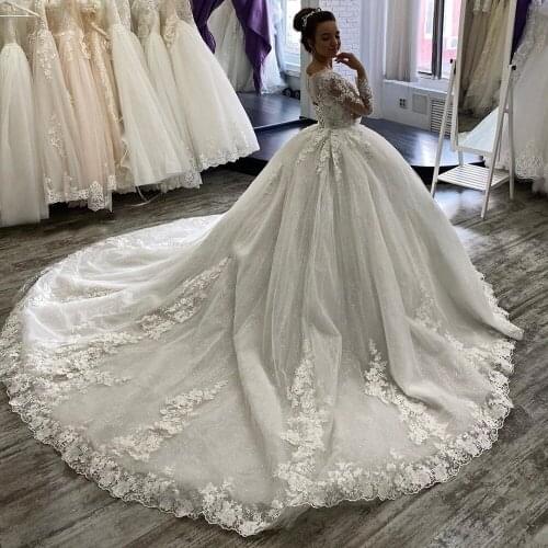 Luxury Long Sleeves Nude Tulle Beaded Neck Princess Ball Gown Bridal Lace Appliques Romantic Church Sparkly Wedding Dress 2021