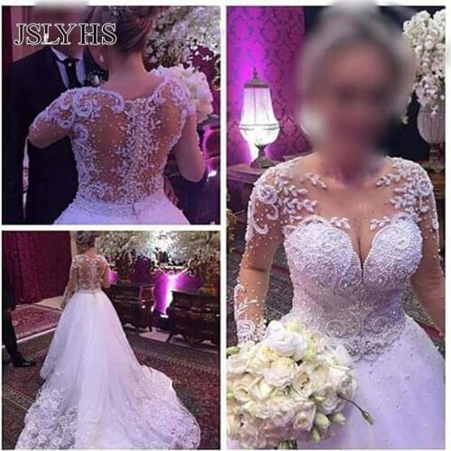 High quality round neck skin tone net White Beige wedding dress luxurious lace tailing long sleeve pearl Sequin bridal dress