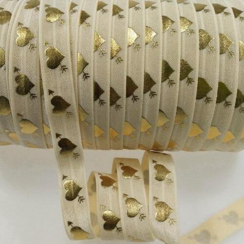 5/8" Valentine design fold over elastic, an arrow through a heart pattern in gold foil printed elastic foe #815,50yards per lot