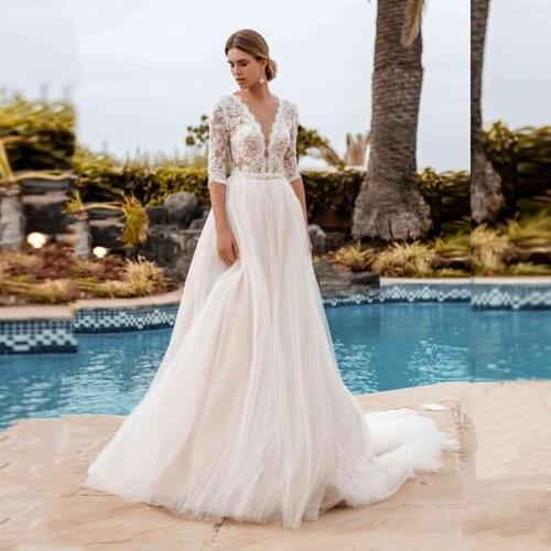 2021 New Graceful Lace Wedding Dresses Ivory with 3/4 Sleeves Beaded Wedding Gowns Illusion Buttons Back Bridal Dresses On Sale