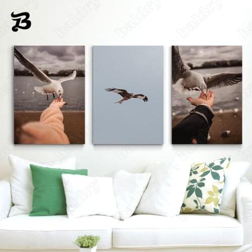 Canvas Painting Wall Art Animals People Reach Out To Feed The Flying Pigeons Posters and Prints for Living Room Home Wall Decor