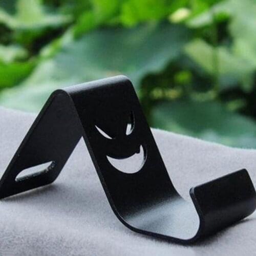 1 Piece Devil Smile Metal Desktop Stand Phone Holder Accessories For Mobile Phones Evil Smail Cool Phone Bracket (Color Random)