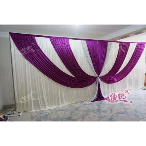 Wedding backdrop with shiny silver sequin and purple swags
