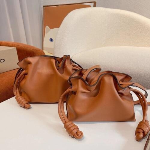 The new stylish one-shoulder stiletto mini draw rope cowhide bucket bag girl flamenco knot simple and simple