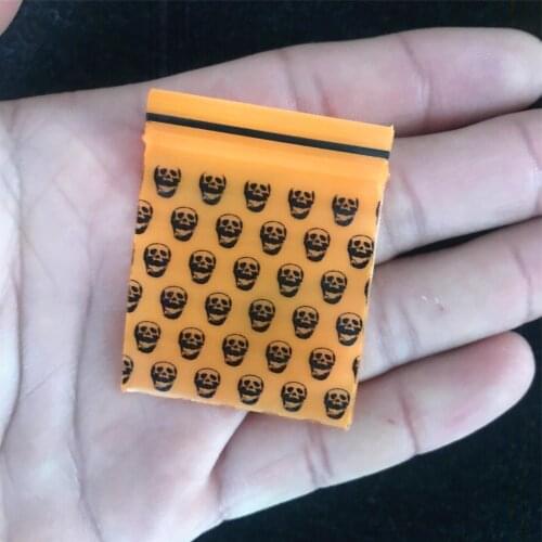 1 Pack (100 pieces)Cartoon new tobacco bag tobacco sealed bag Smoke storage bag Orange skull pattern Tobacco sealed bag