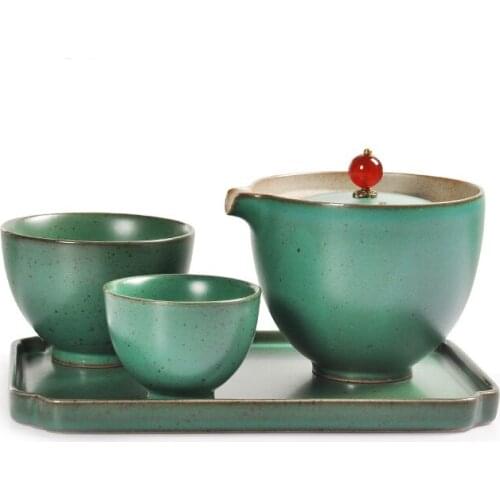 A pot of two cups and a plate of Japanese stoneware tea set portable travel kung fu tea set kiln becomes a quick guest cup