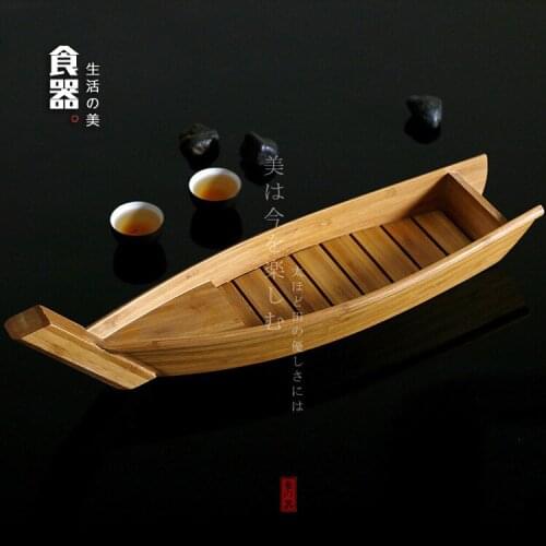 Japanese sushi bamboo boat artistic conception salmon lobster dry ice long cooking boat dish seafood and radish raw fish plate
