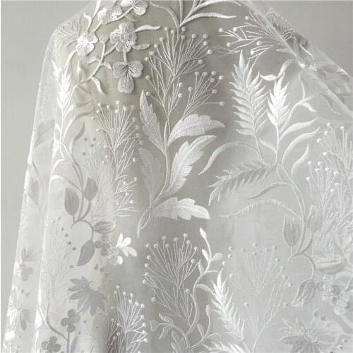 Wholesale lvory african lace fabrics with pearls embroidery designs for lace wedding dress