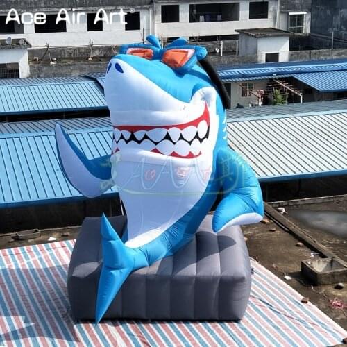 Hot sale funny 5 m H smiling inflatable shark sitting on the stone cartoon sea animal model for advertisement or entertainment