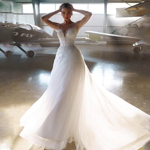 A Line Pearl Wedding Dress Sexy Illusion Long Sleeves Round Neck Glitter Tulle Bridal Gown Sweep Train Dresses