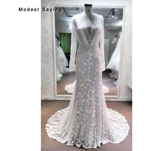 Luxury Mermaid Beaded Lace Wedding Dresses 2018 with V Neckline Sexy Backless Long Sleeves Bridal Gowns with Champagne Lining