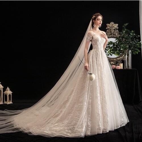 2021 Luxury Shiny Wedding Dresses Short Sleeve A-Line Dubai Saudi Arabia 3D Lace Sequin Bead Backless Princess Train Bridal Gown