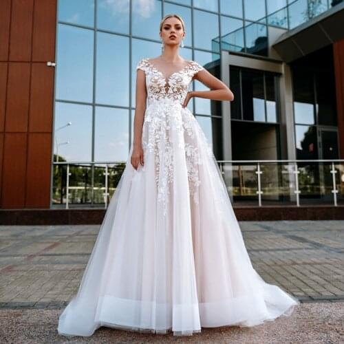 2021 Illusion Scoop Cap Sleeve Wedding Dresses A-Line Lace Appliques Button Bridal Gown Vestidos De Noiva Floor Length