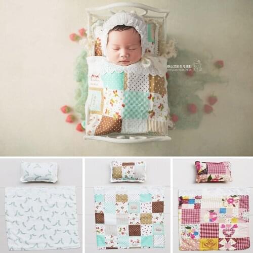 Baby baby is wrapped in a blanket and pillow at the first full month newborn photograohy props