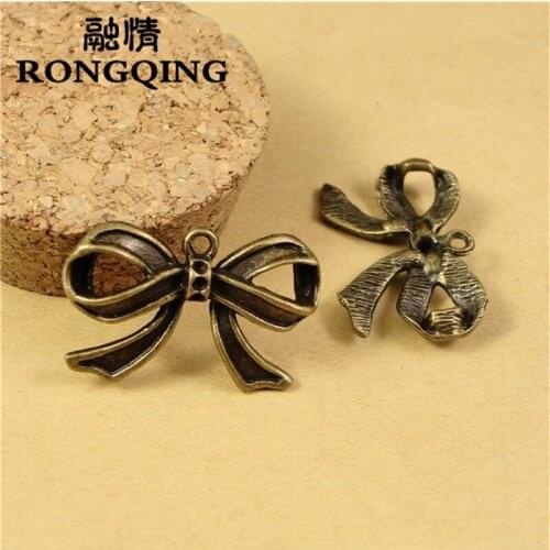RONGQING 40pcs/lot 29*18MM Bow tie Bronze Charms handmade Craft pendant making fit DIY for bracelet necklace