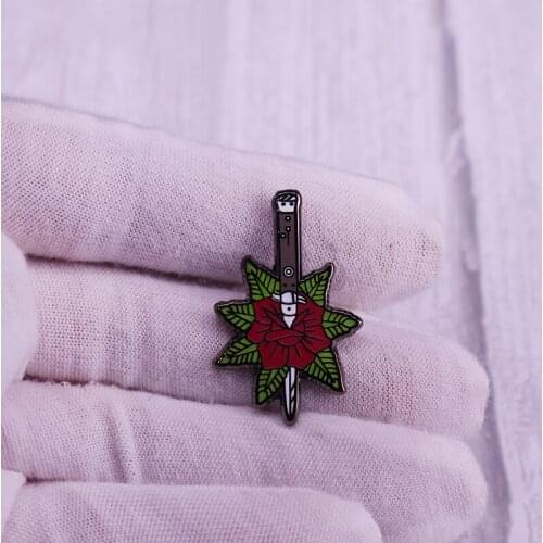 Dagger knife and rose flowers badge