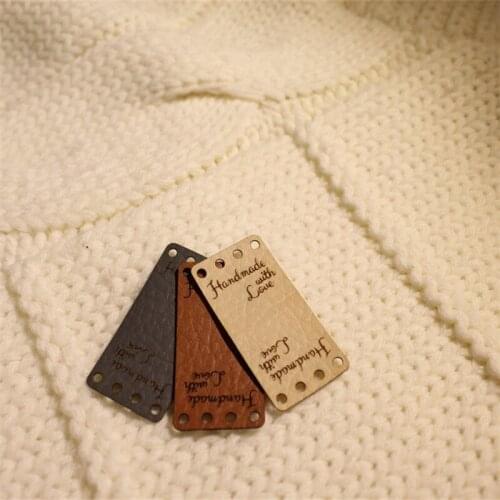 Custom labels, center fold labels, faux leather labels, faux leather tags, folding tags, knitting leather label