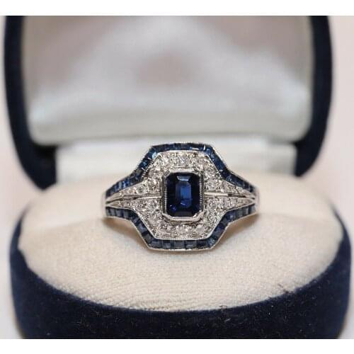 ANTIQUE ART DECO PLATINUM NATURAL DIAMOND AND CALIBER SAPPHIRE DECORATED RING