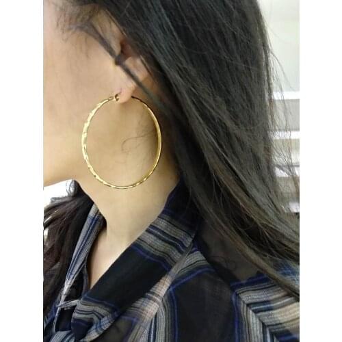 Large gold earrings with single stripes