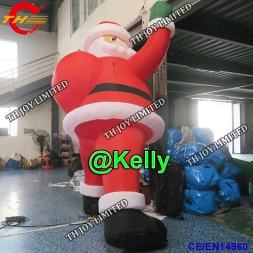Free air shipping 6m high christmas promotional inflatable santa with gift bag, wall climbing inflatable santa claus for sale