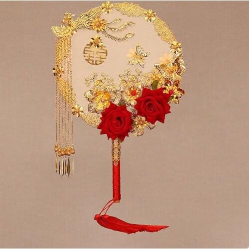 Chinese bride covers her face and holds flowers in her hand. Ancient style wedding, wedding, group fan, wedding luxury hand fan