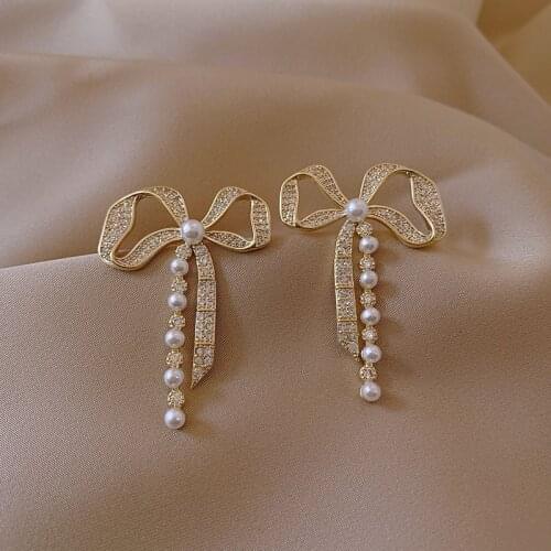Metallic material bowknot shape pearl tassel earrings female east door minority personality cold wind earrings