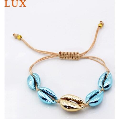 Cowrie seashell mussel bracelet seashell jewelry blue and gold bezel charm
