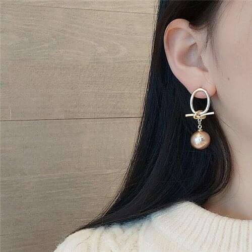 U-Magical Temperament Champagne Faux Pearl Dangle Earrings for Women Gold Alloy Tie Bow Hollow Out Earrings Jewelry Pendientes