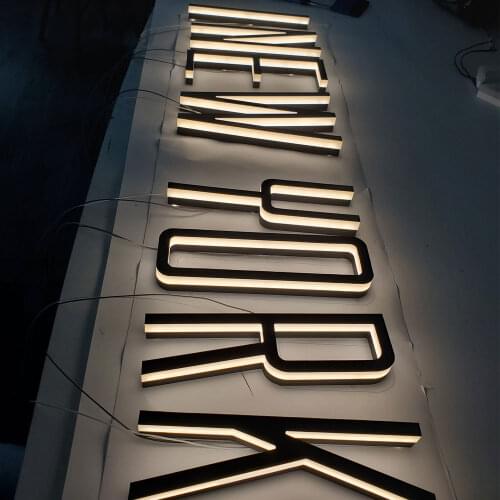Black edge-lit acrylic cut led letter painted face warm light