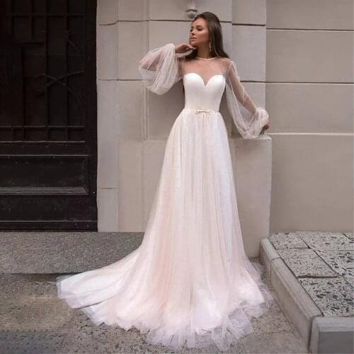 2021 Charming Champagne Wedding Dresses Long Sleeves Illusion Neckline Bow Belt Wedding Gowns Pearls Bridal Dresses Sheer Back