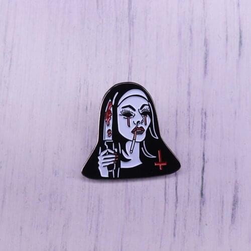 Nun girl dress killer to Halloween festival Shes holding a knife badge brooch