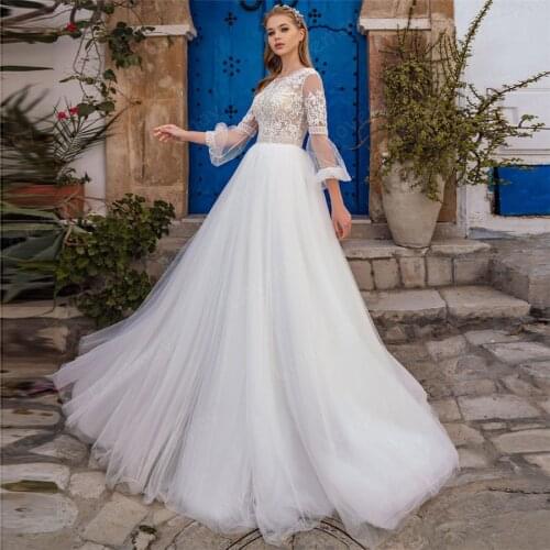 2021 Long Sleeves Beach Wedding Dresses O Neck Sequined Lace Appliques Button Illusion Sweep Train Boho Bridal Gown Vestidos