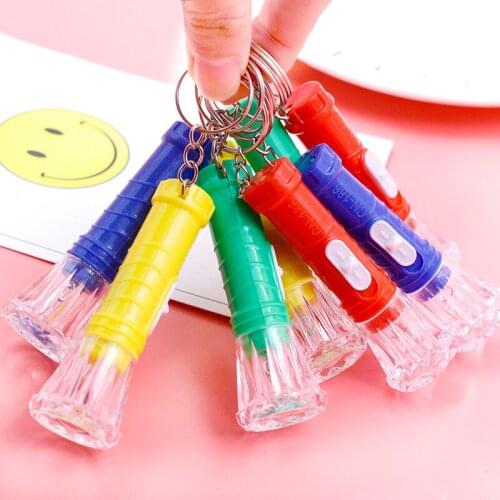 Small flashlight keychain mini small battery lamp key ring pendant wholesale authentic led luminous toys wholesale