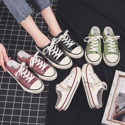 In the summer of 2021, the new small daisy semi-towed canvas shoes for women are lazy and versatile white shoes