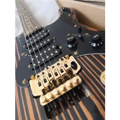 Free shipping custom 6 string electric guitar,Zebra wood body and neck,tremolo bridge,HSH pickups,black guard,gold buttons