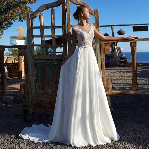 Charming A-Line Chiffon Wedding Dresses 2021 Sheer Scoop Neck Cap Sleeve Lace Appliques Sweep Train Bridal Gown With Bow Belt