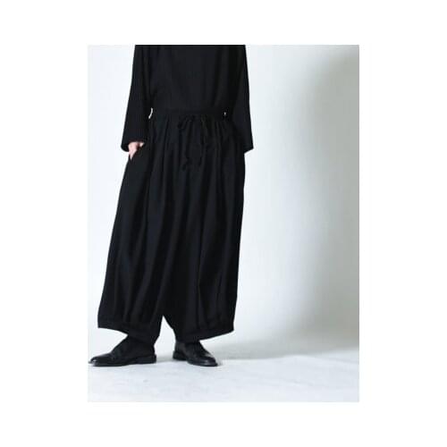 The new wide-legged mens culottes are super-loose, wrinkled, dark and baggy