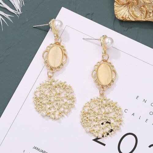 Fashion simple hollow snowflake earrings temperament wild alloy imitation pearl womens earrings trend exquisite charm