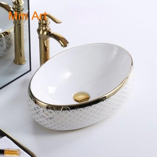 Wholesale decorative no hole oval gold golden luxury hotel ceramic table top bathroom sink wc hand wash art basin Bathroom sink