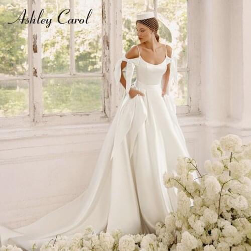 Ashley Carol A-Line Wedding Dress 2021 Beaded Spaghetti Straps Satin Bow Decorative Pockets Bride Backless Princess Bridal Gowns