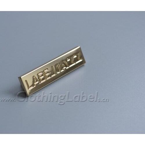 Custom metal brand label for bags, engraved logo, with leg and rivet at back side