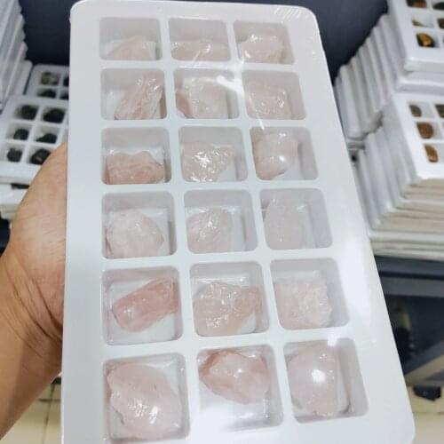 A box of natural rose quartz crystal stone ice pink crystal ore raw rock mine specimens