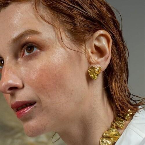 Asymmetrical earrings womens European and American lava studs retro pleated jewelry bump irregular brass earrings