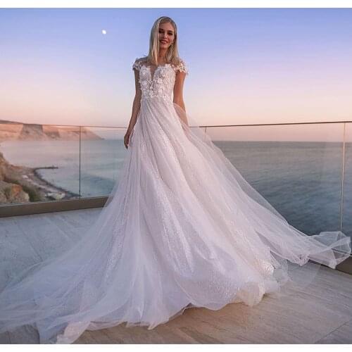 KapokDressy O Neck Cap Sleeves Button Sparkly Tulle A-Line Wedding Dresses Appliqued Flowers Pearls 2021 New Long Bridal Gowns
