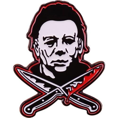 Myers Over Crossed Bloody Knives Glow In The Dark Pin Depicting the face of 1981 Halloween slasher movie villain