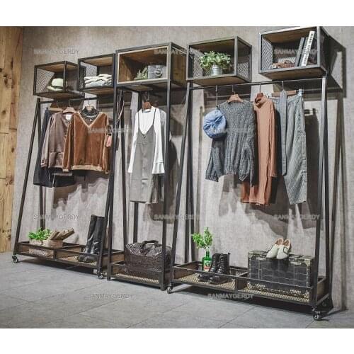 Clothes hangers. Display rack floor-mounted wheeled retro womens clothing store shelves. Iron side hanging decorative