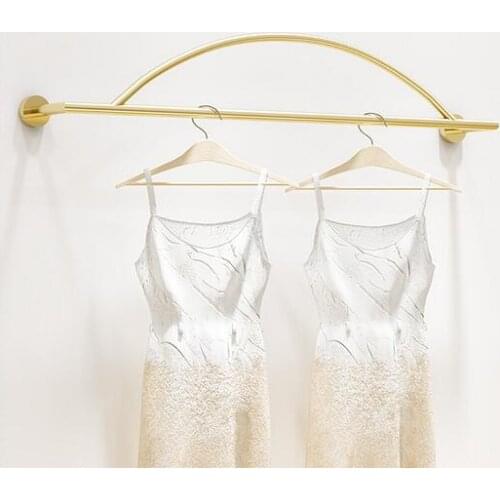 Clothing store display shelves on the wall creative wall hanging mens and womens hooks on the simple wall bar is hanging gold